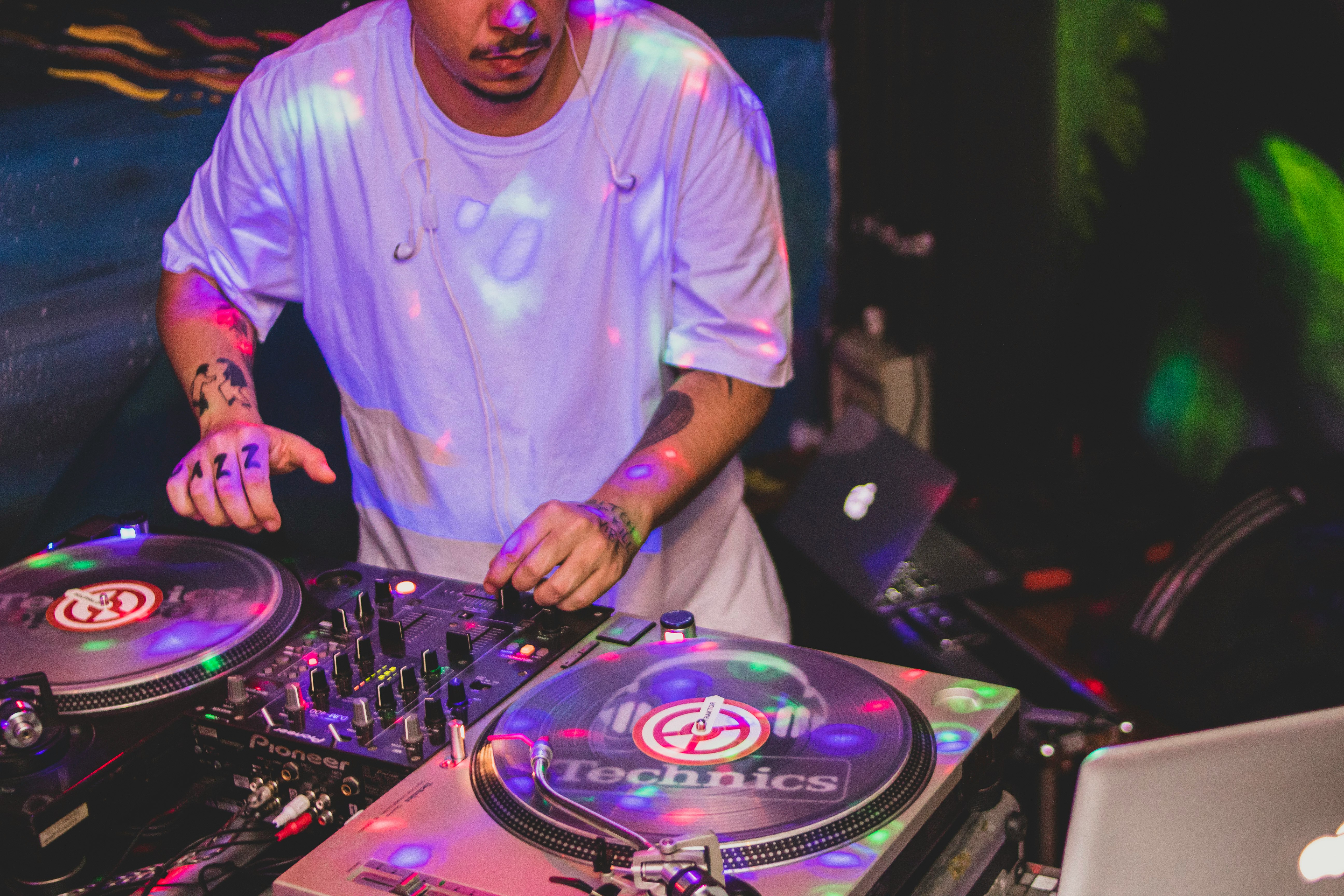 man in blue crew neck t-shirt playing dj controller